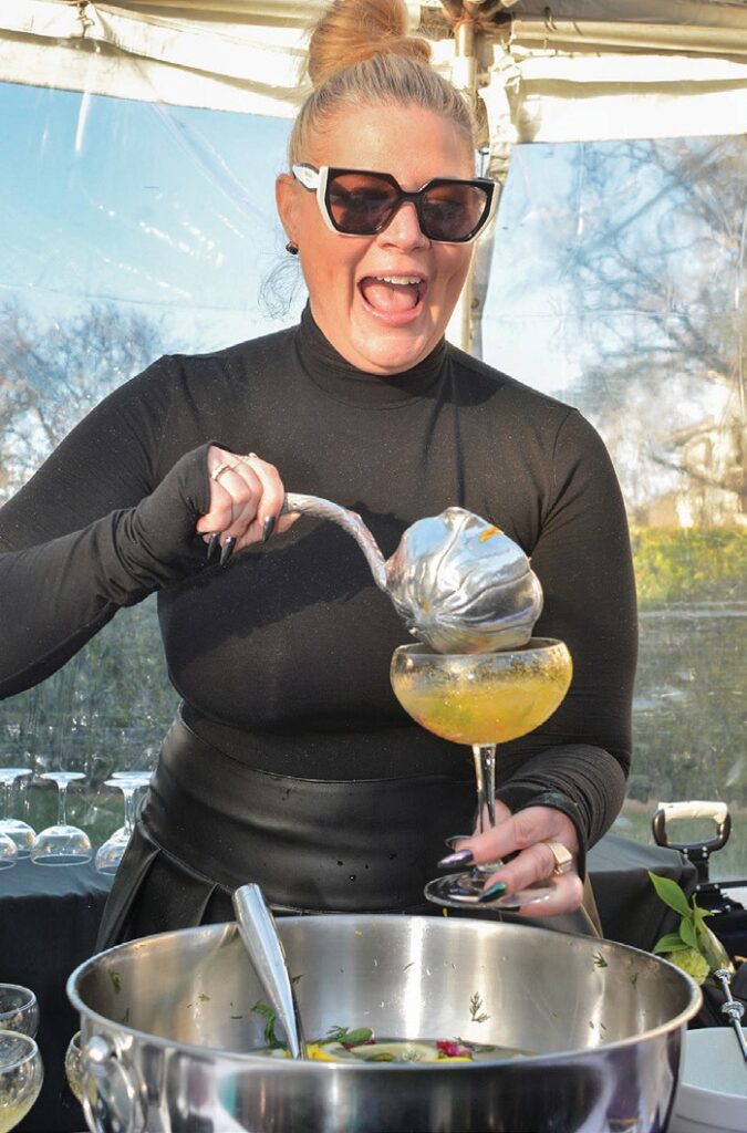 TASTY TREATS—Amy Jo Williby prepares for guests a Wilde Irish Gin punch with honey, lemon and aloe during the Senior Concerns’ 50th anniversary celebration March 15 at the Hyatt Regency Westlake.